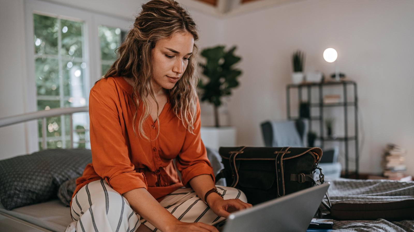 Woman looking at laptop at home. Woman looking on laptop at home.