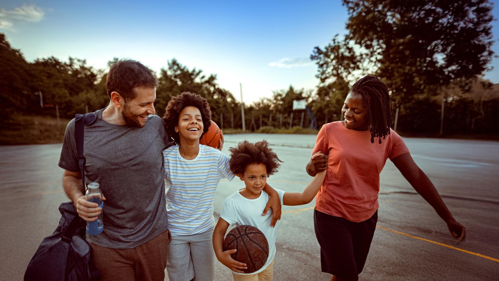 Happy family going home after playing sports