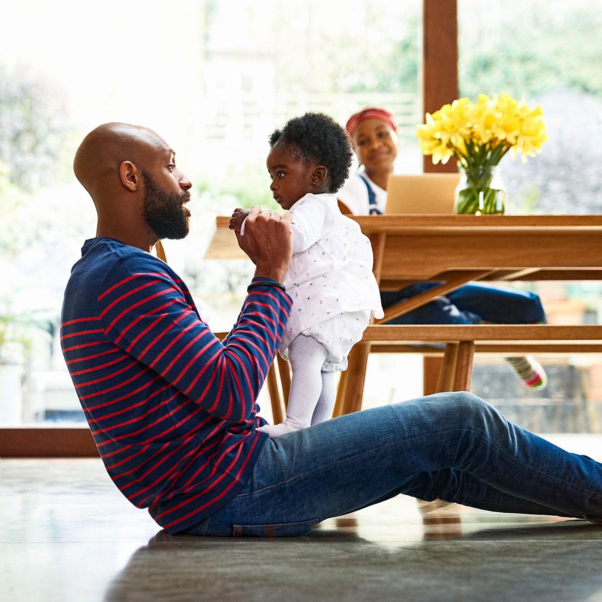 Father and daughter playing at home.