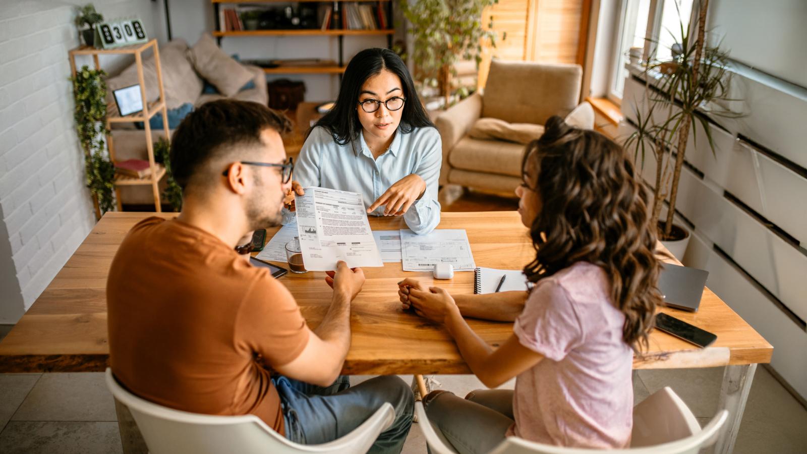 Couple talking to finance advisor at home