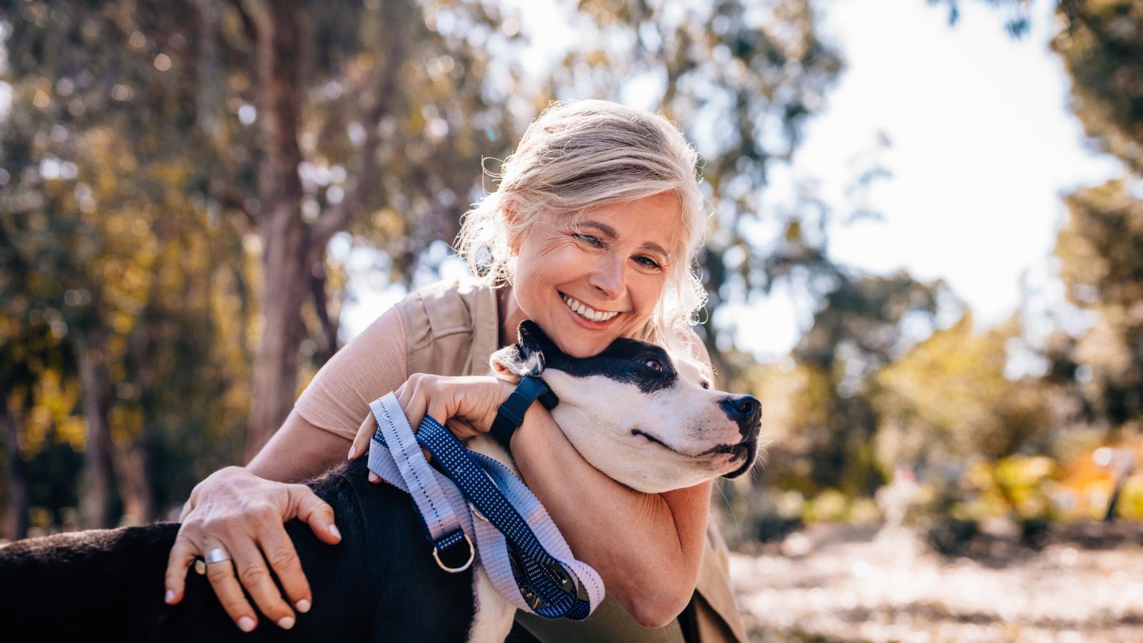 Mature woman outside with her dog Mature woman outside with her dog