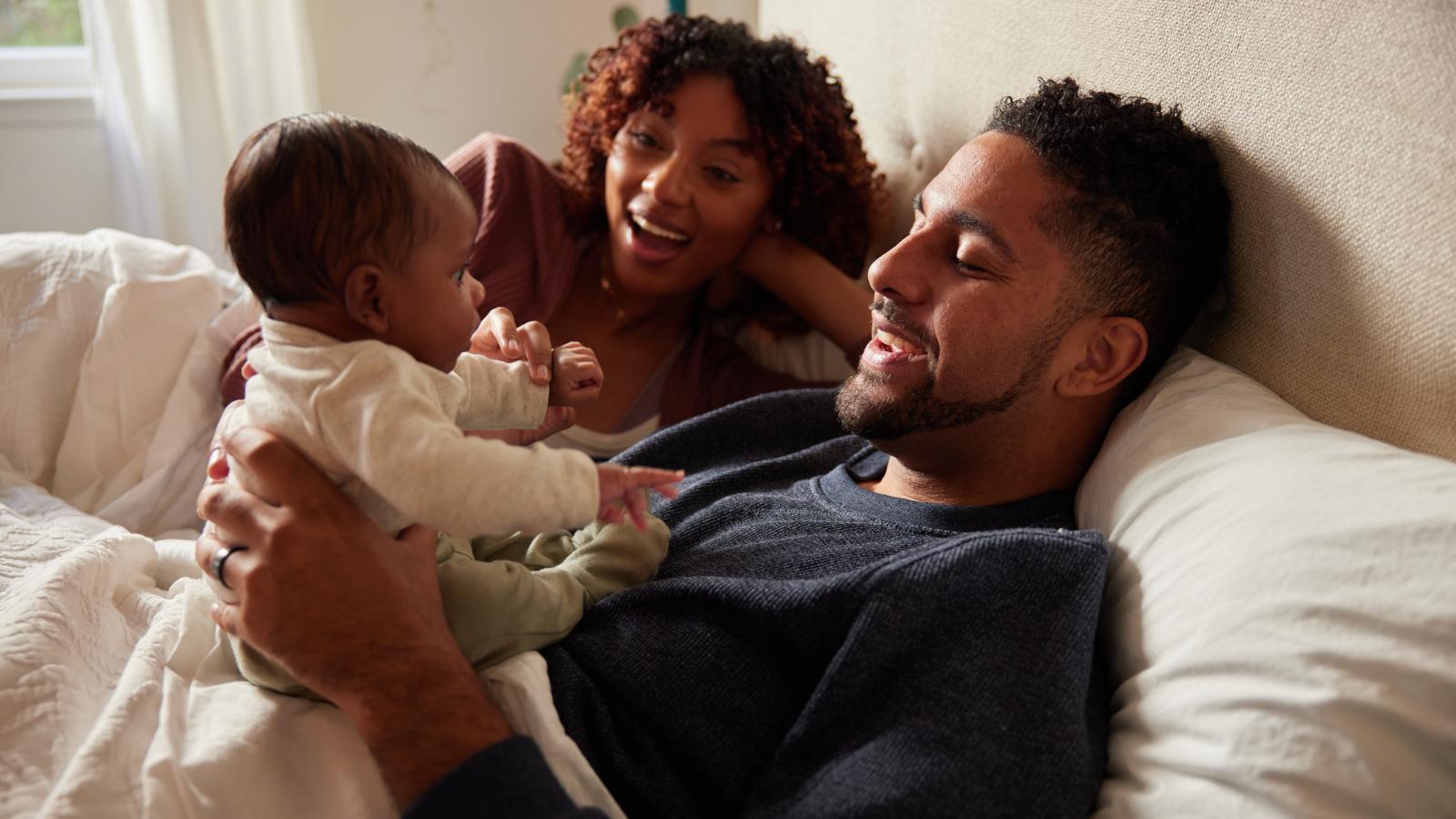 Mom and dad playing with their baby