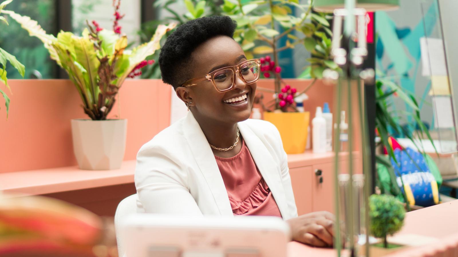 Woman smiling behind desk