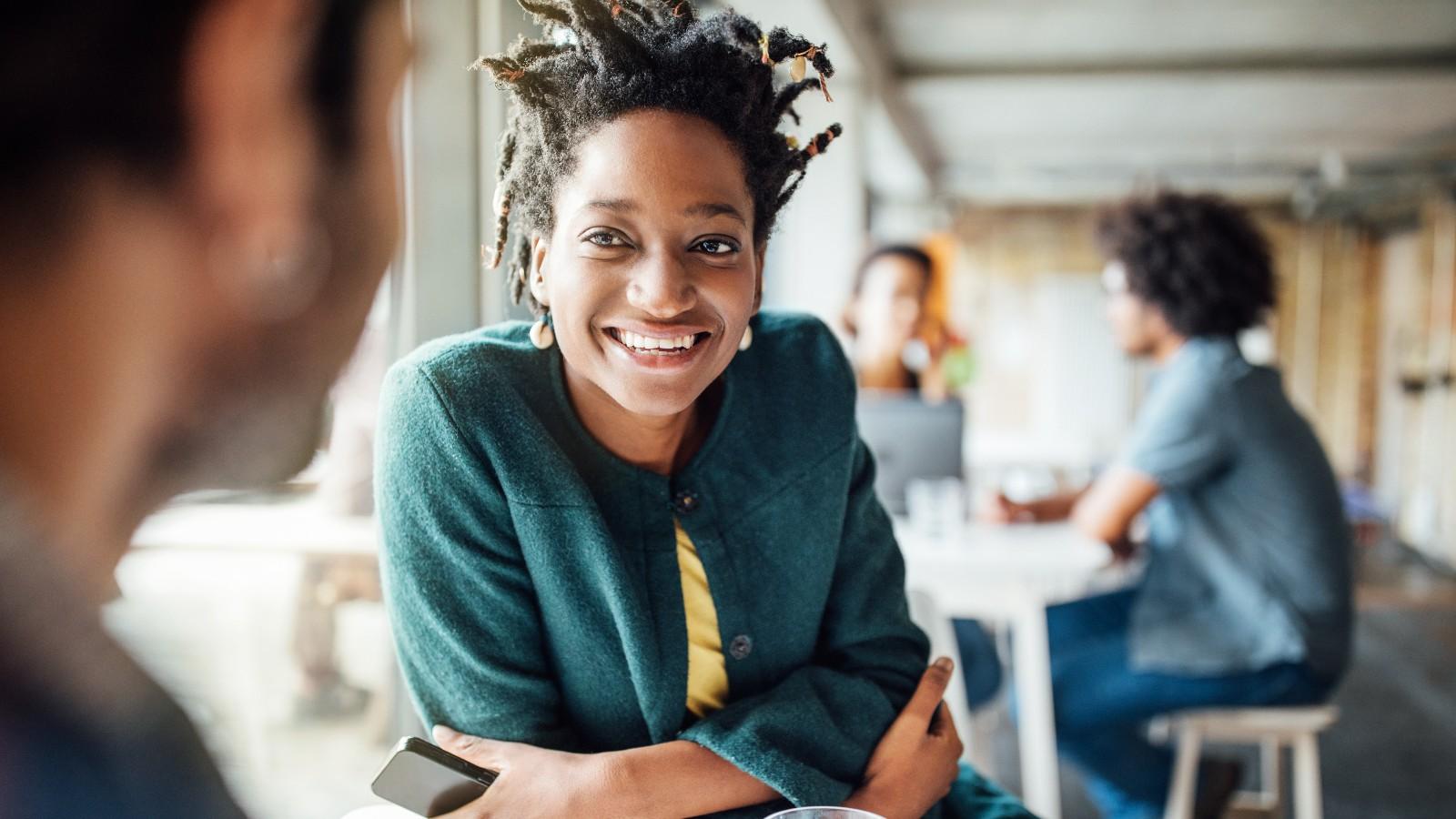 Woman smiling while looking at a man