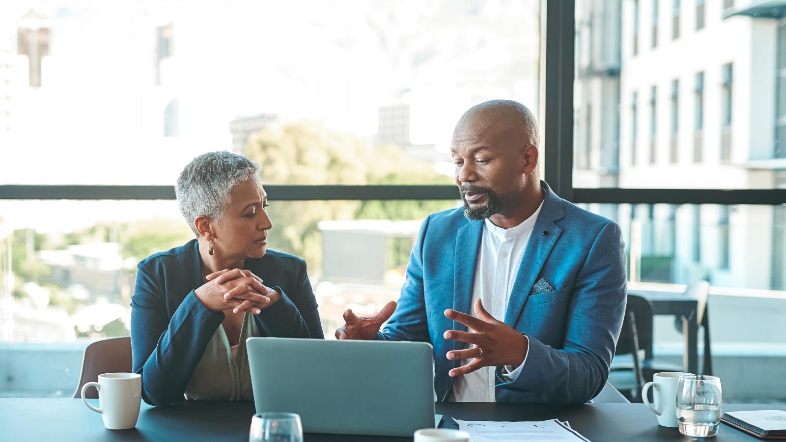 Business people with laptop discussing using laptop