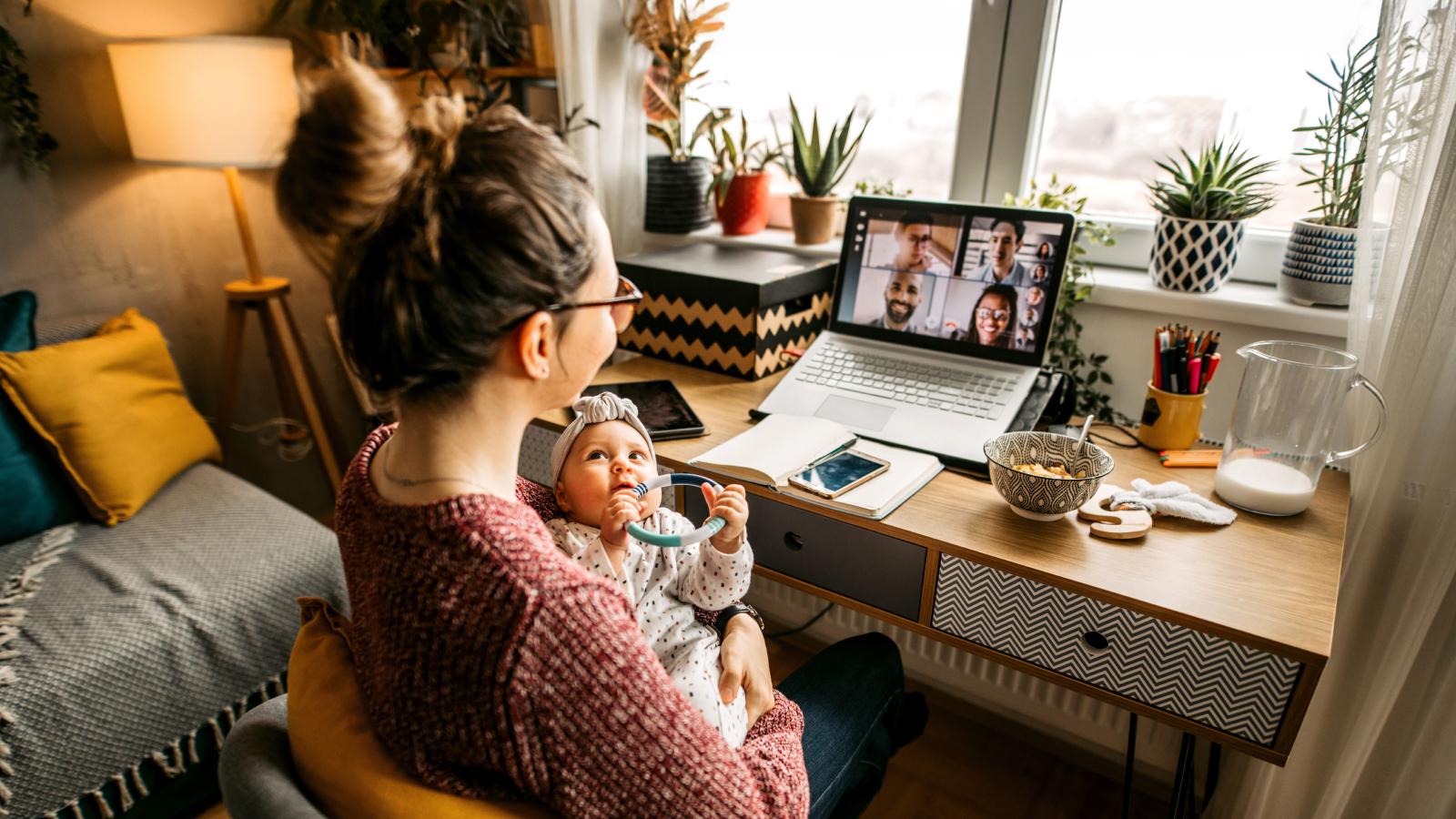 New mother working holding a toddler