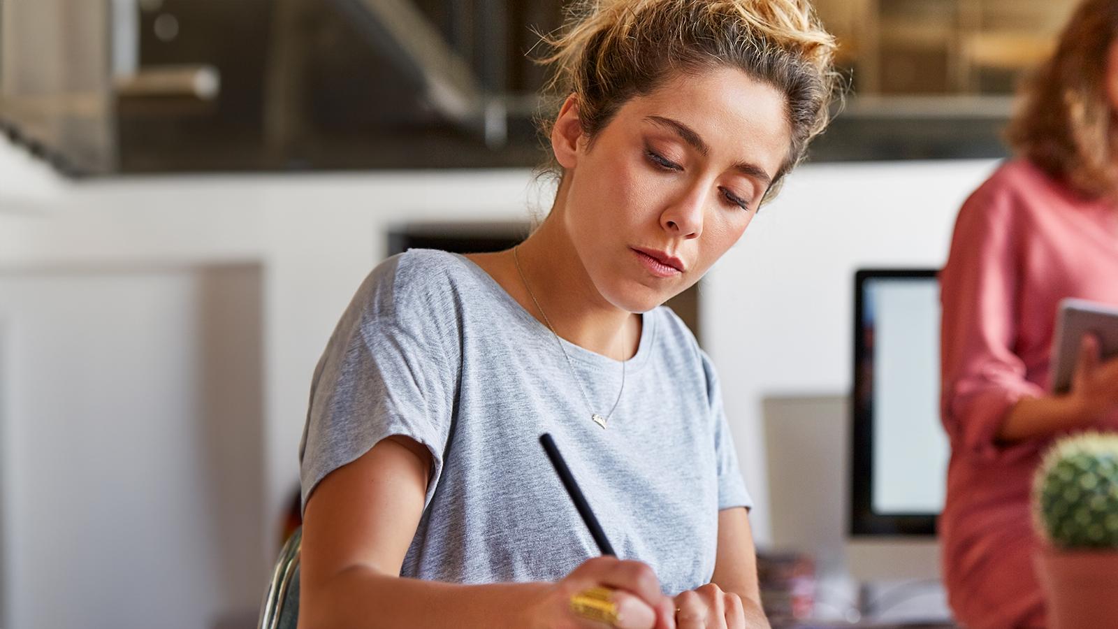 Woman writing at her desk