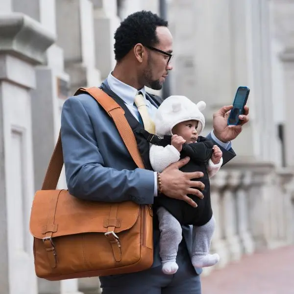 Dad with baby on the phone .