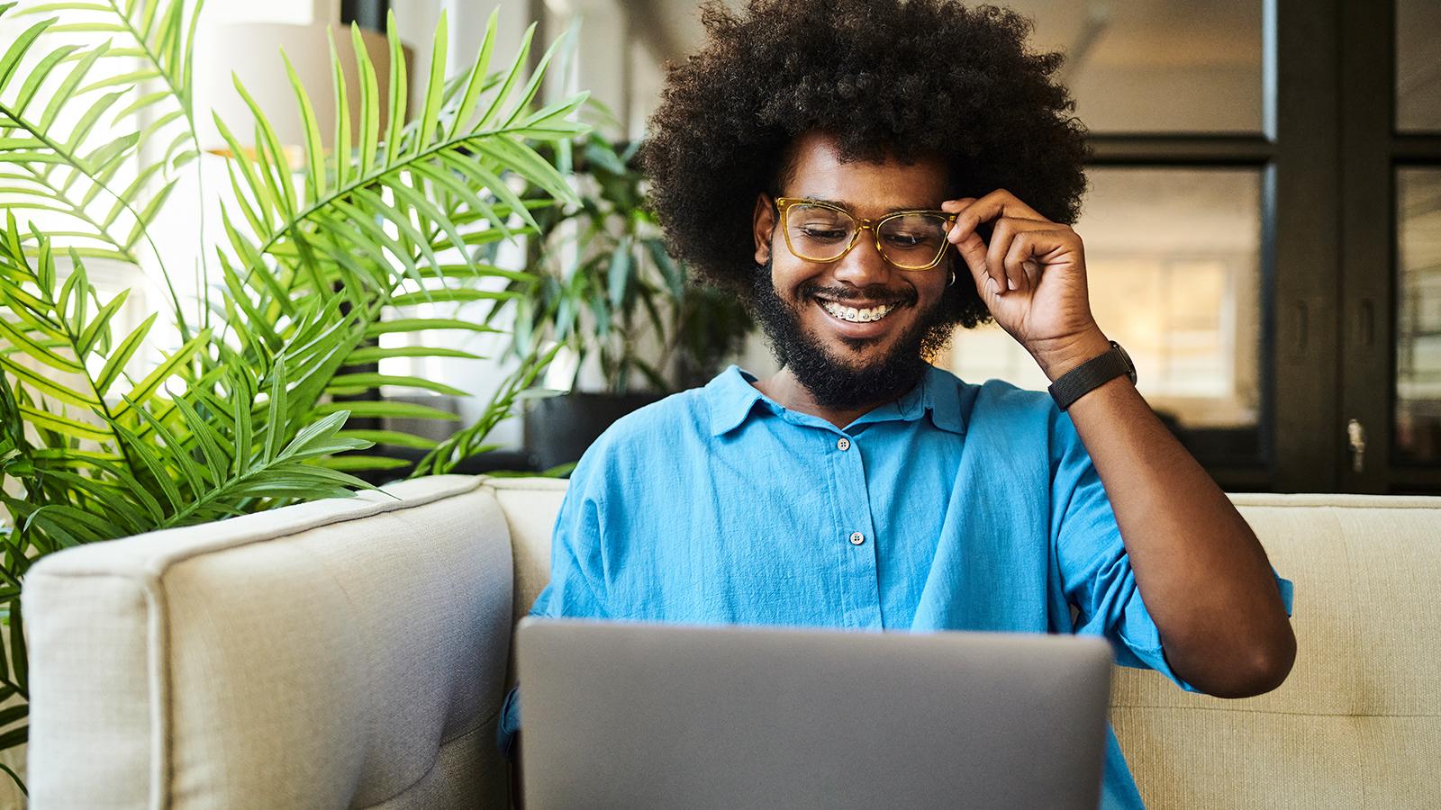 Man watching a webinar on his laptop. Man watching a webinar on his laptop.
