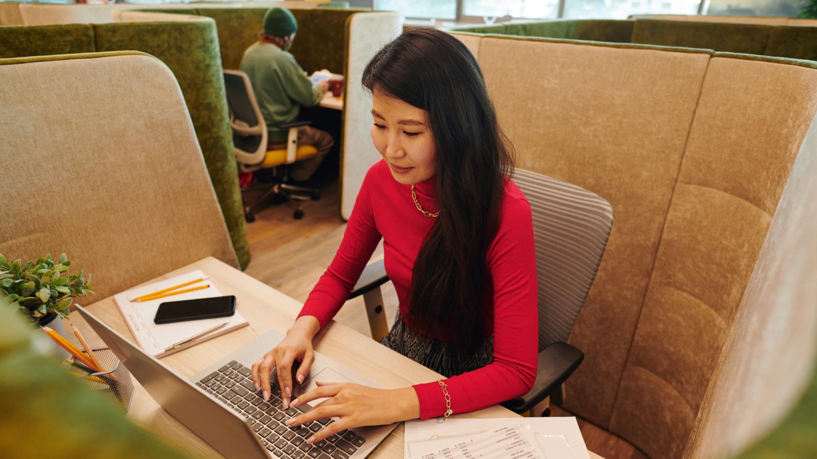Office manager in smart casualwear looking at laptop