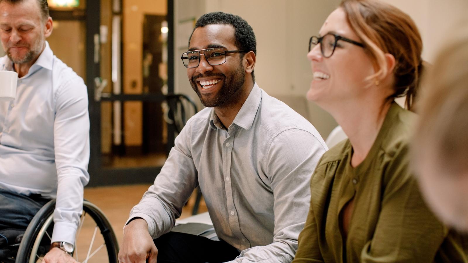 Business professionals smiling during sales meeting in office