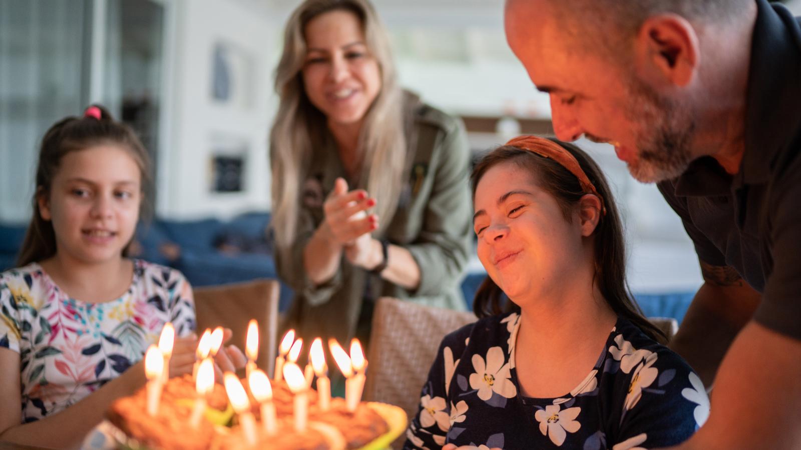 Family celebrating birthday of a child with special needs. Family celebrating birthday of a child with special needs.