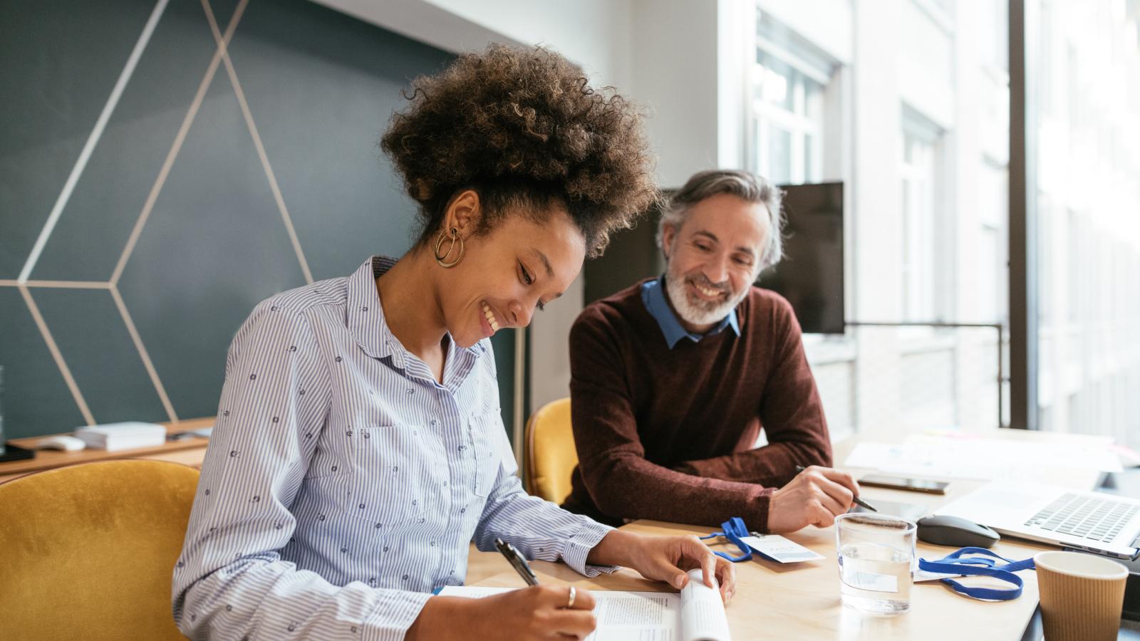 Broker and client happily discussing insurance options