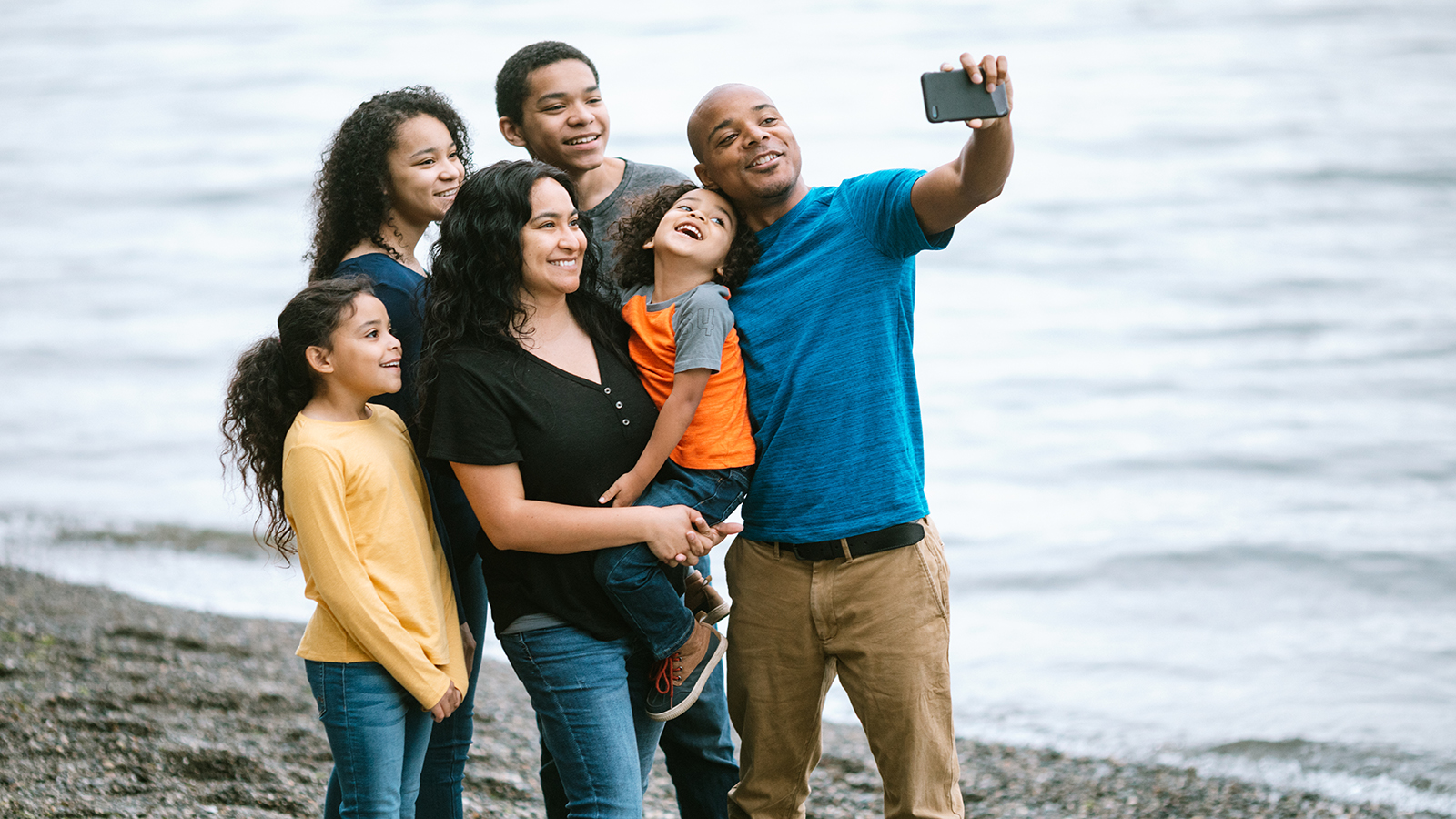 family taking photo on the beach