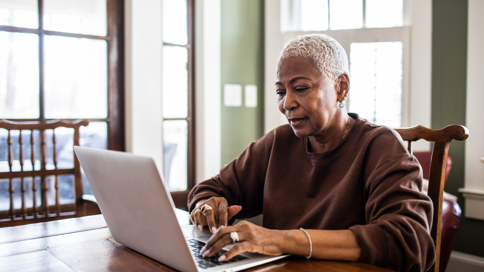 Senior woman using laptop at home
