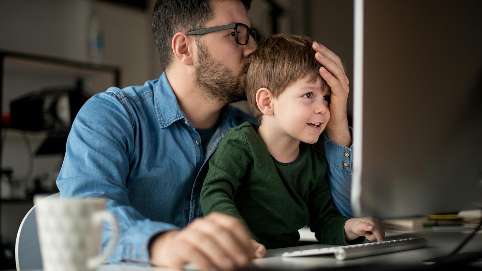 Man sitting with his border collie looking at a smartphone