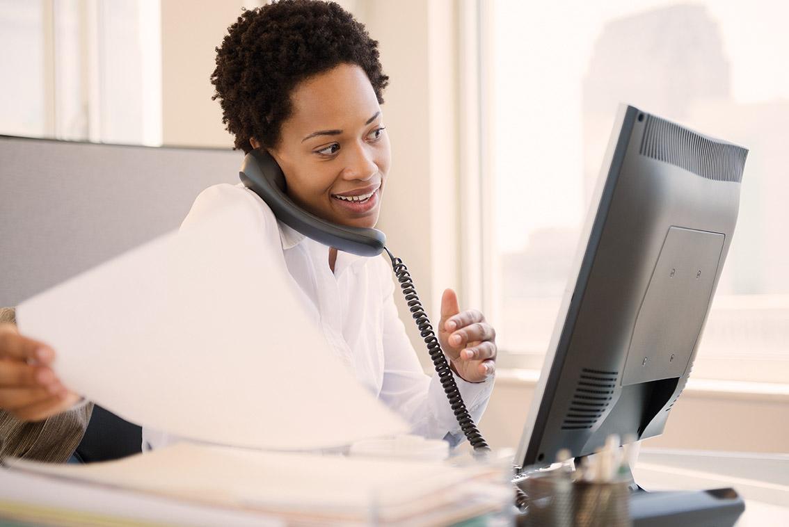Woman broker on the phone getting a quote.