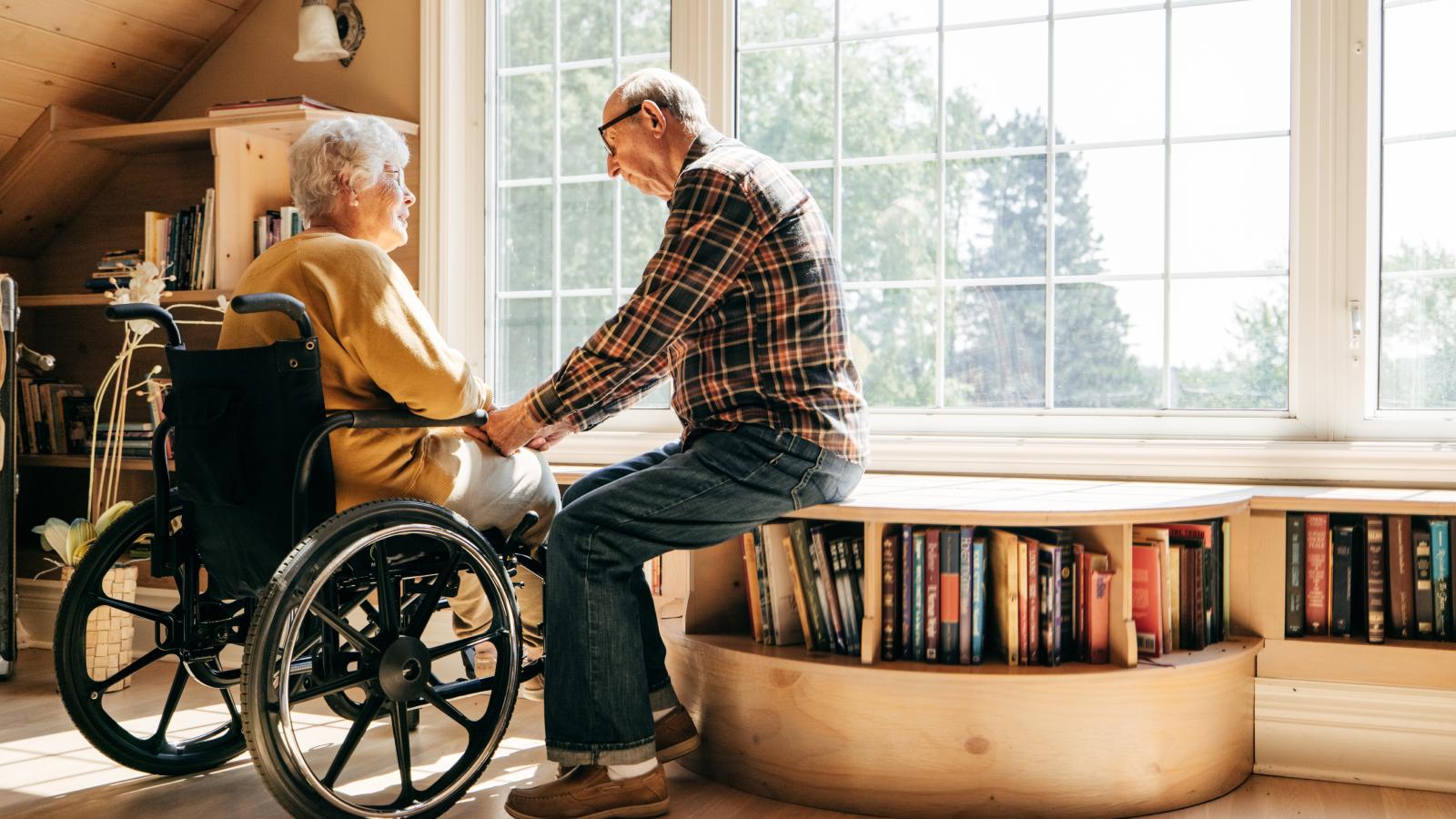 Elderly couple holding hands