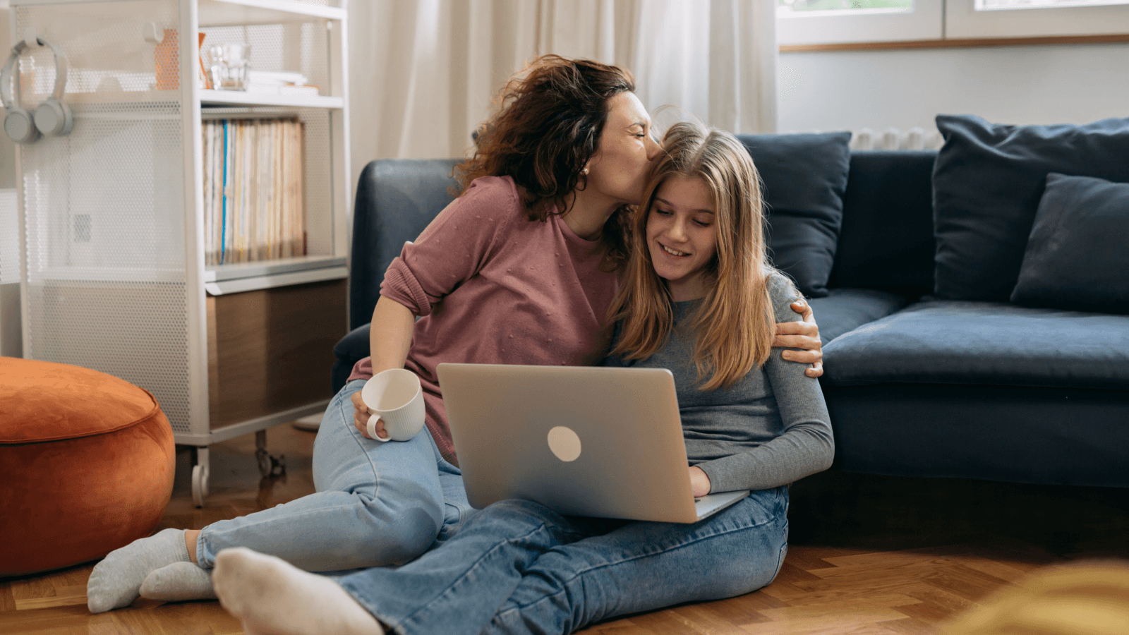 Mother embracing teenage daughter at home