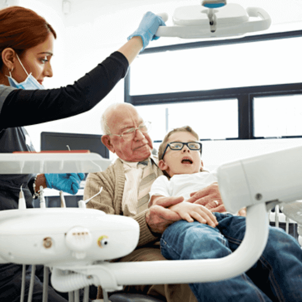 A grandfather with his grandson at the dentist office.
