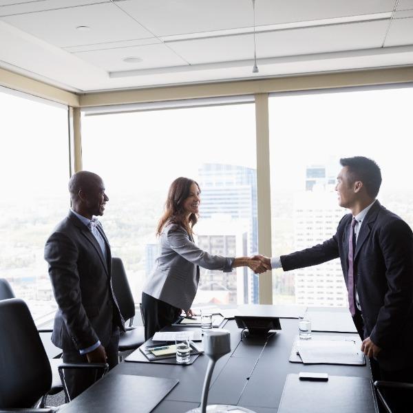 A woman shaking hands with manager.