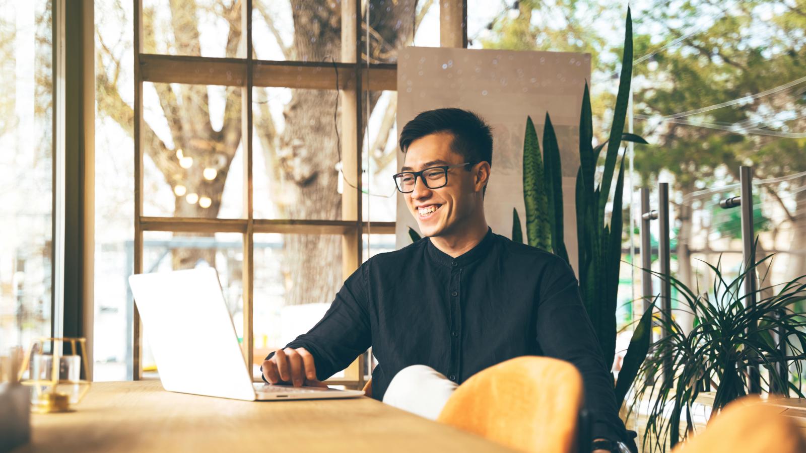 Young entrepreneur video calling at office