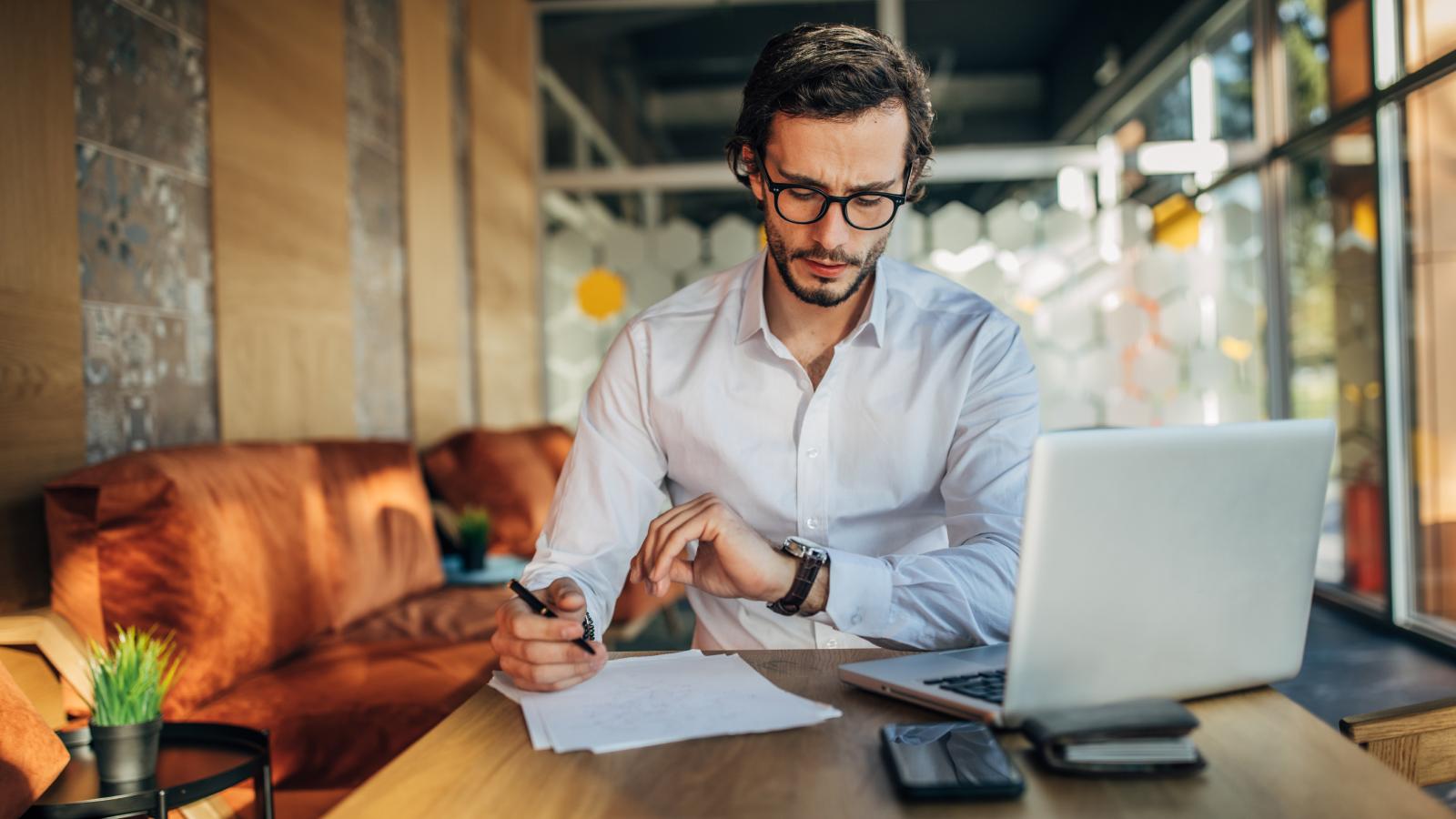 Businessman working on laptop in cafe