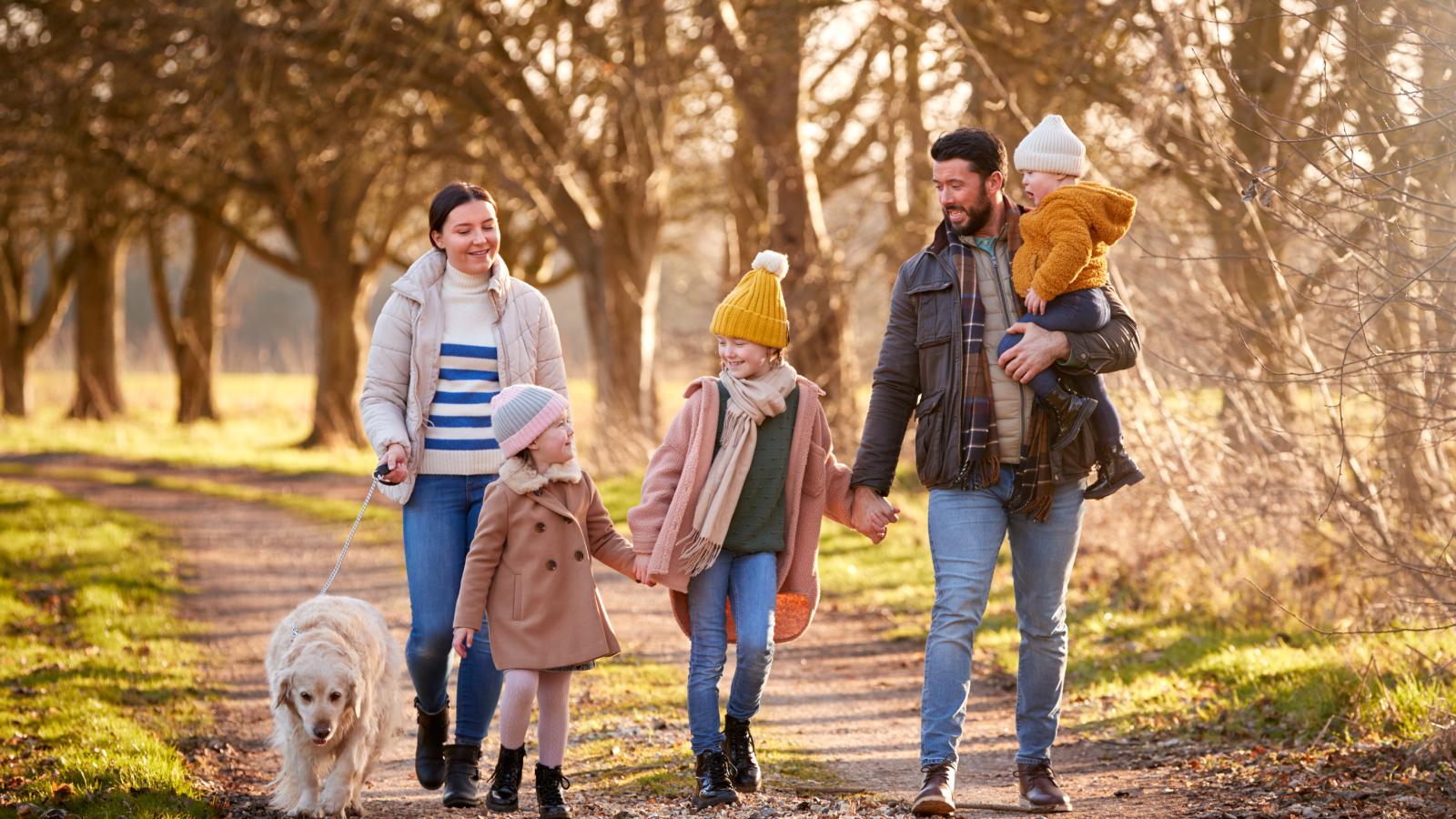 Family with dog walking in garden