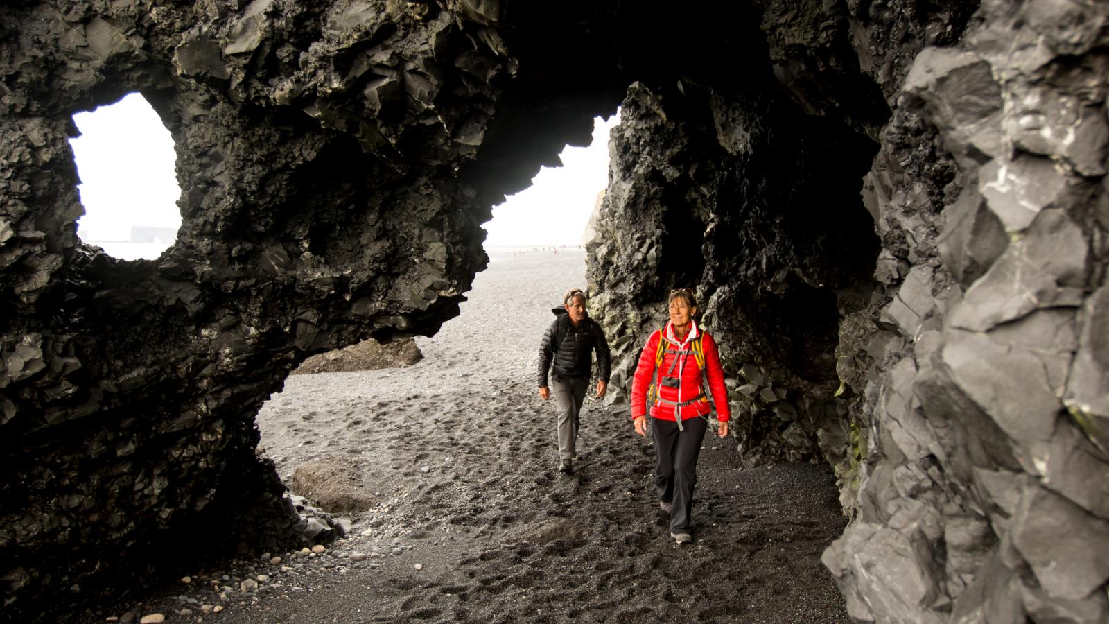 Two people hiking on the beach