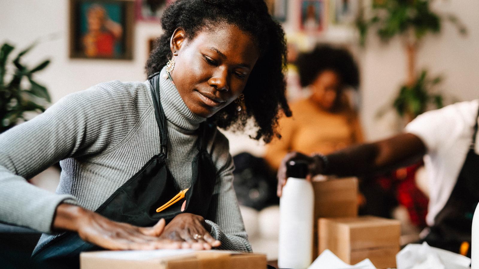 Woman at work sealing a package