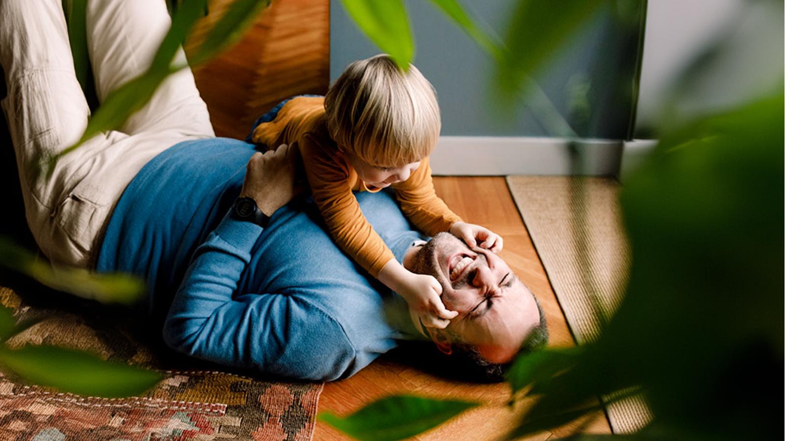 Father and son playing on the the floor