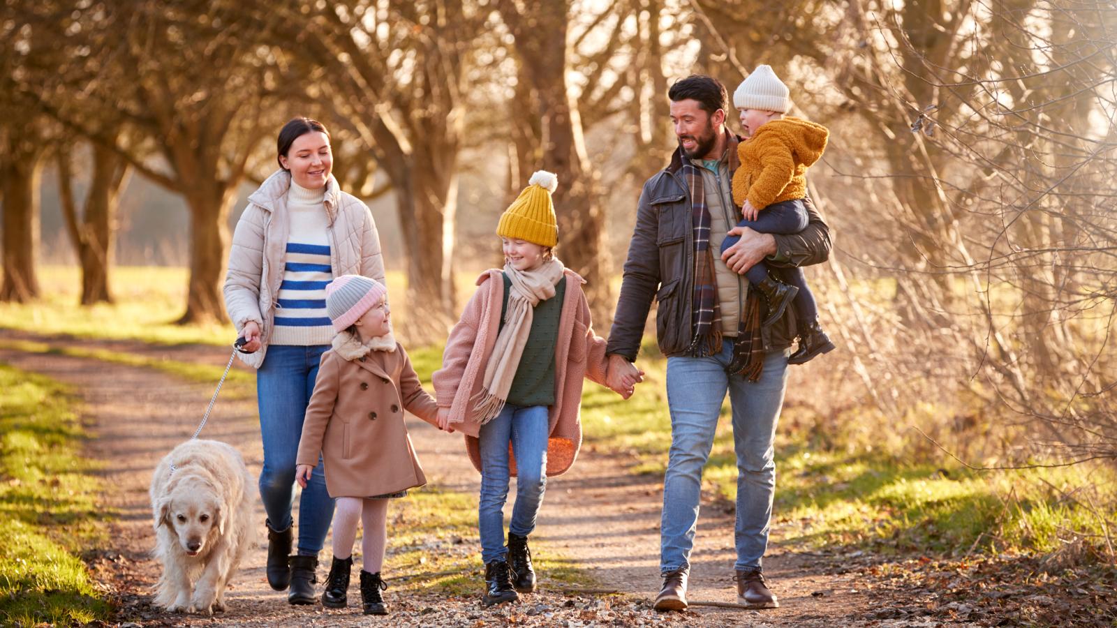 Family walking with pet dog