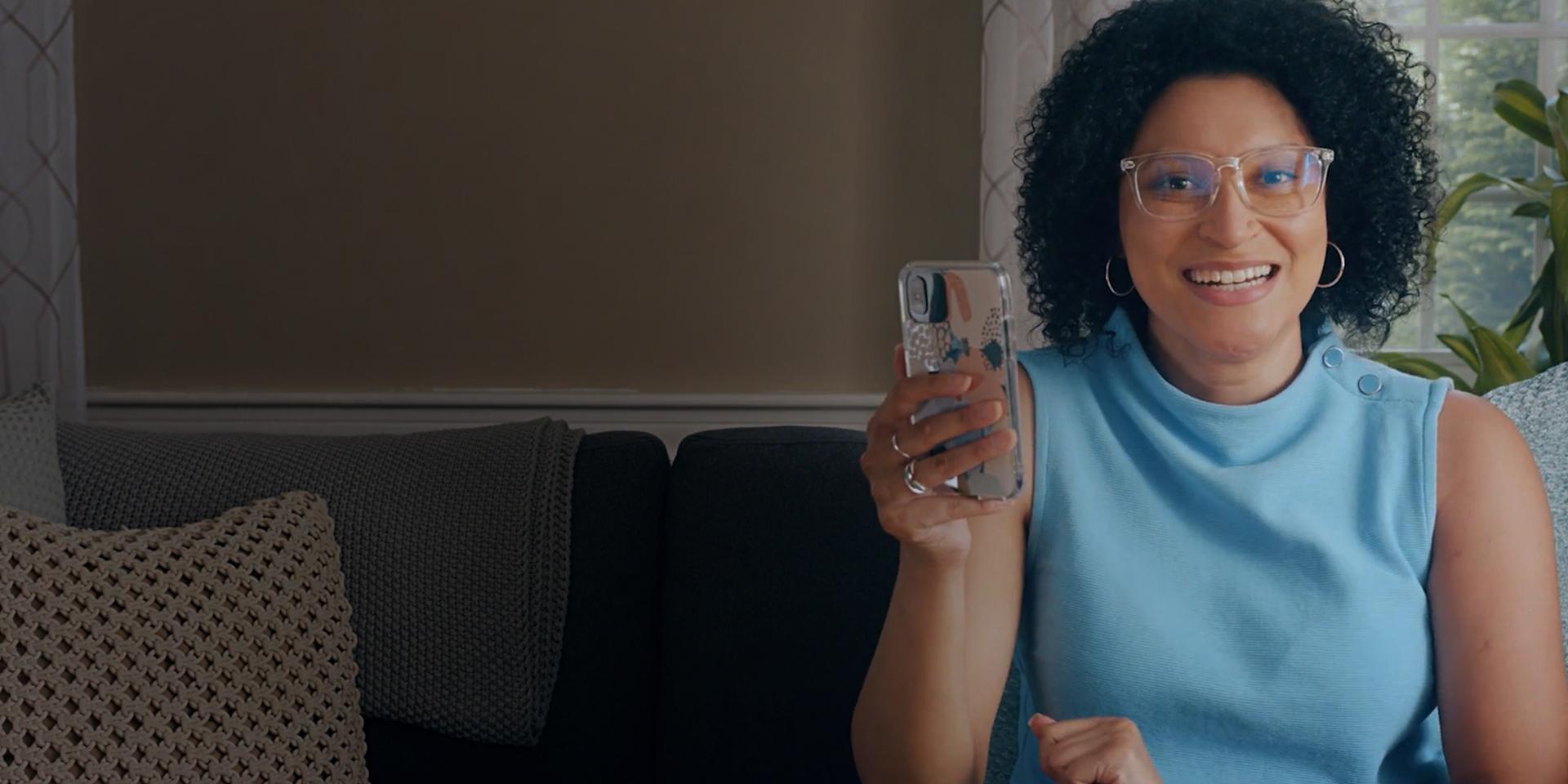 Kelly from Simply Put holding up a mobile phone Kelly from Simply Put holding up a mobile phone