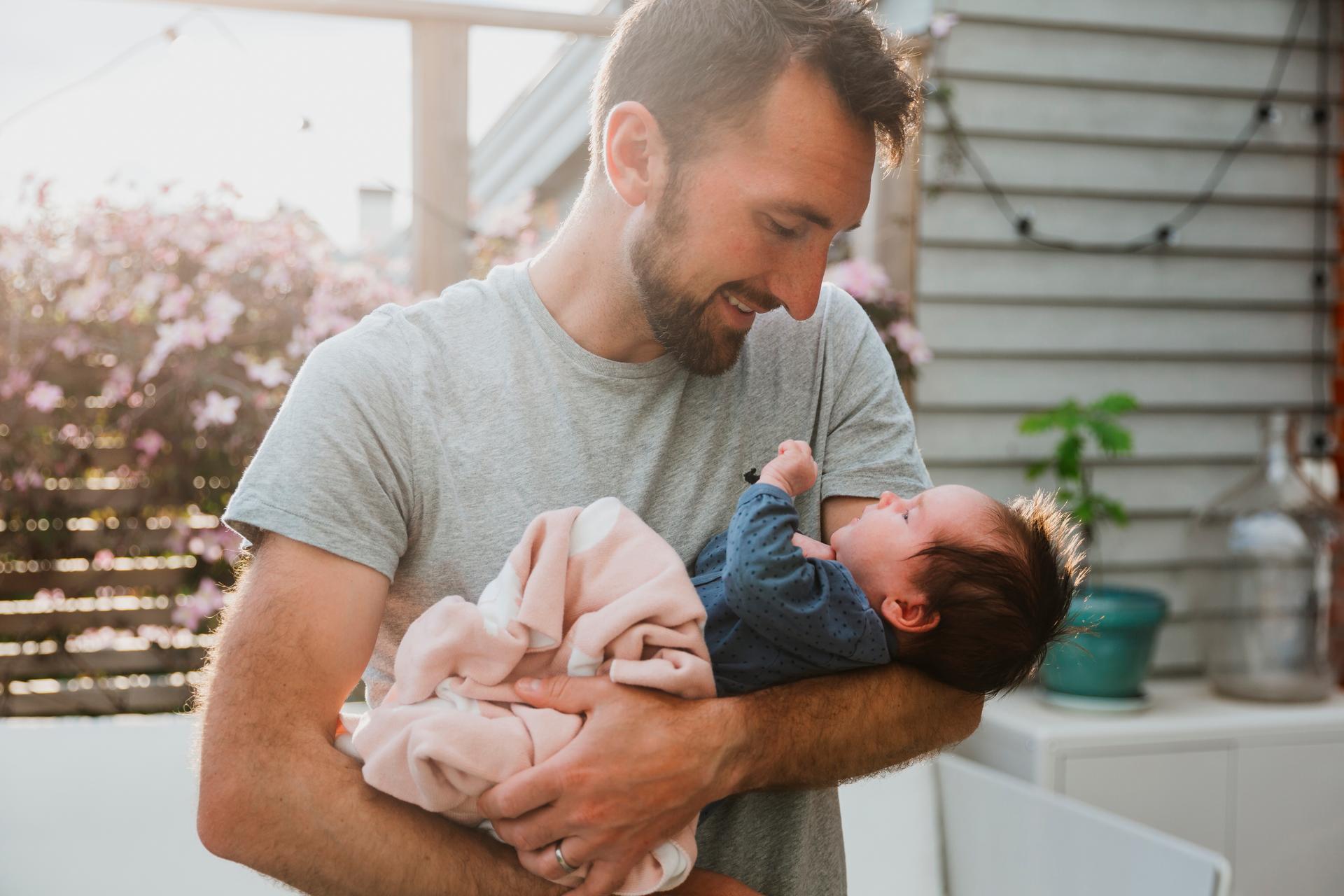 Father holding his daughter outside