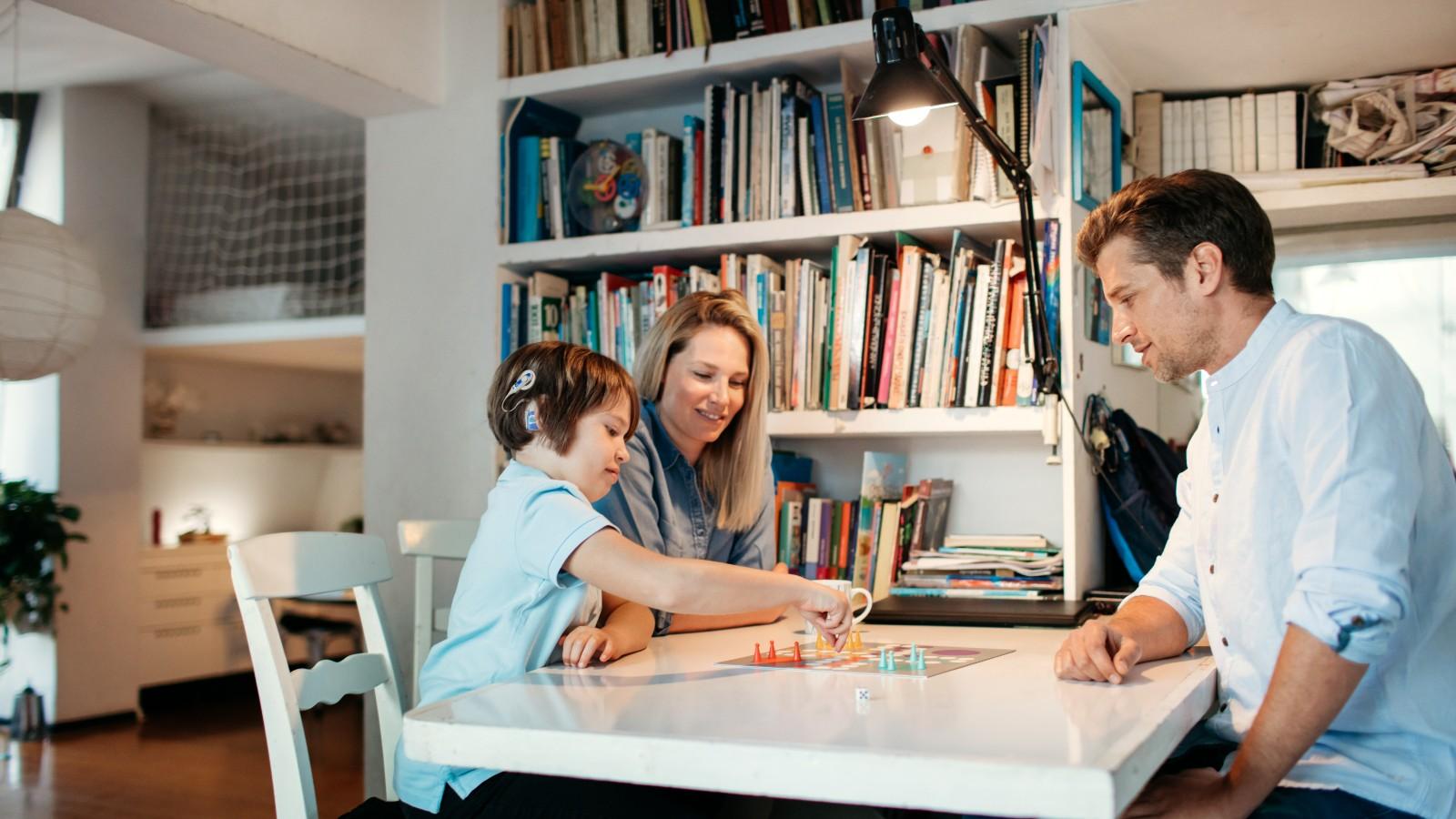 family playing board game