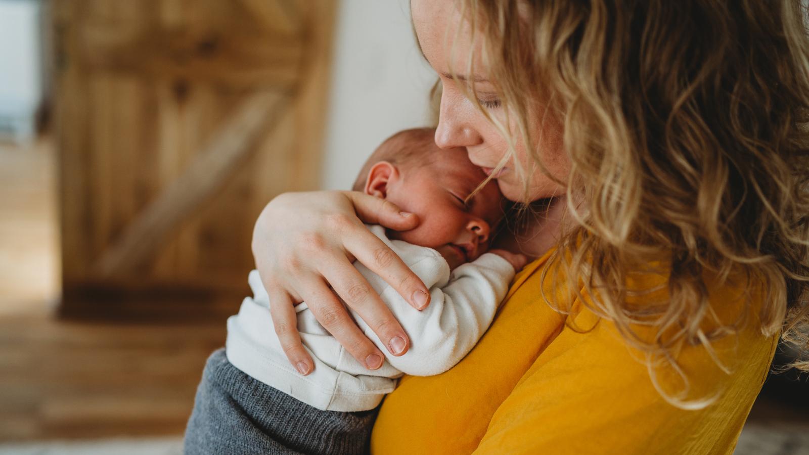 Mom holding newborn baby in her arms