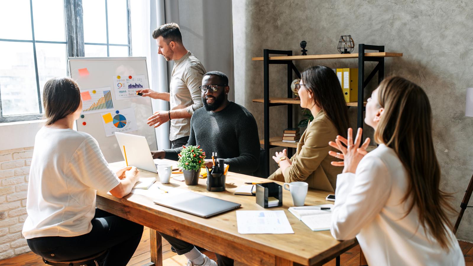Multiracial team discuss tasks at meeting