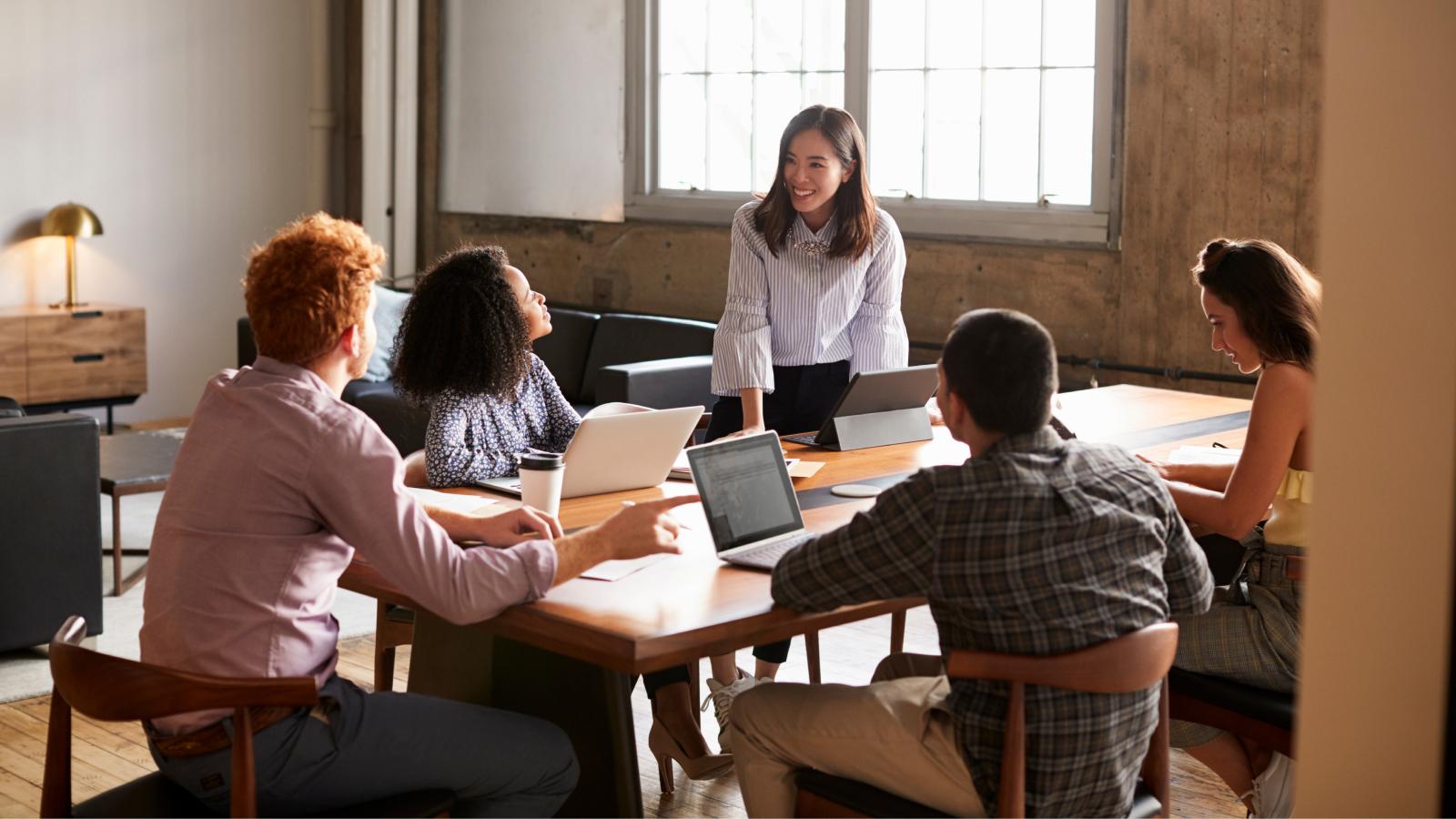 Woman addressing colleagues at a work meeting