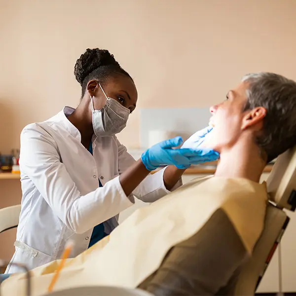 Dentist examining a patient's teeth.
