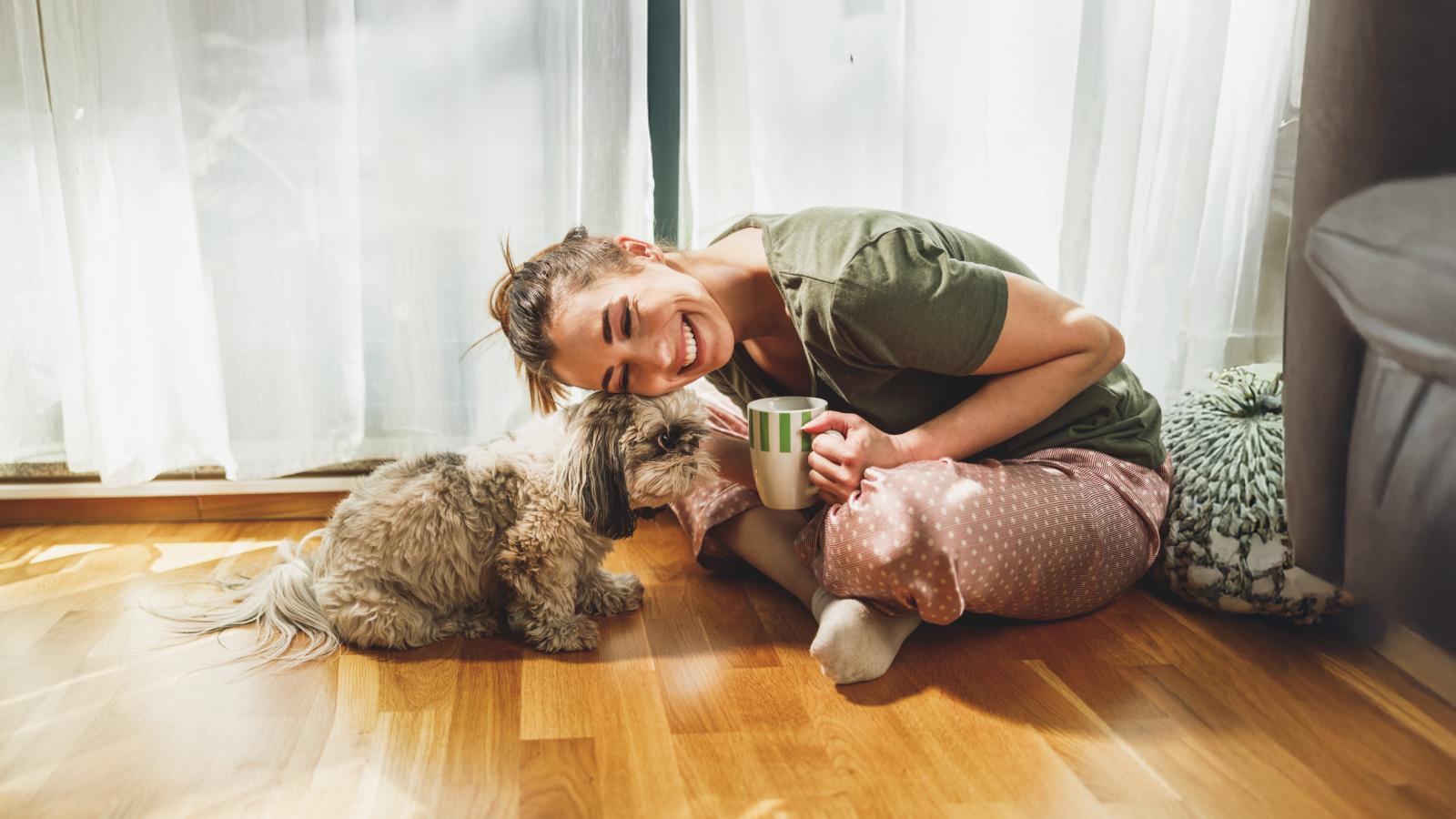 Woman enjoying coffee with her dog