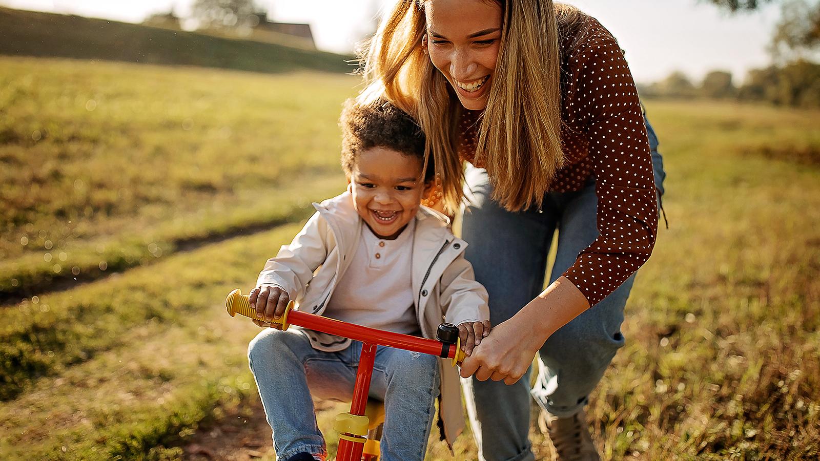 Mother teaching her son how to ride a bike