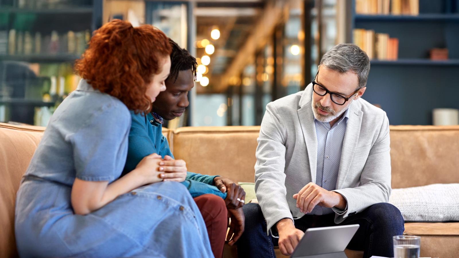Couple discussing with financial representative