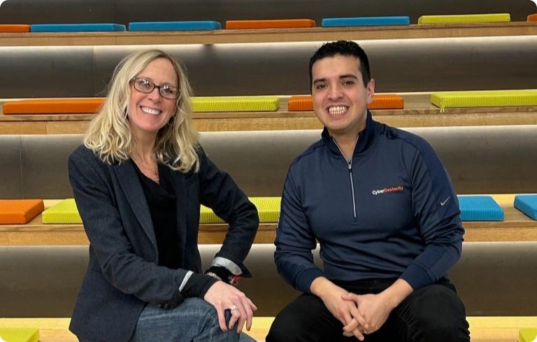 Tara and Esteban sit side by side on bleachers in the Guardian office Tara and Esteban sit side by side on bleachers in the Guardian office