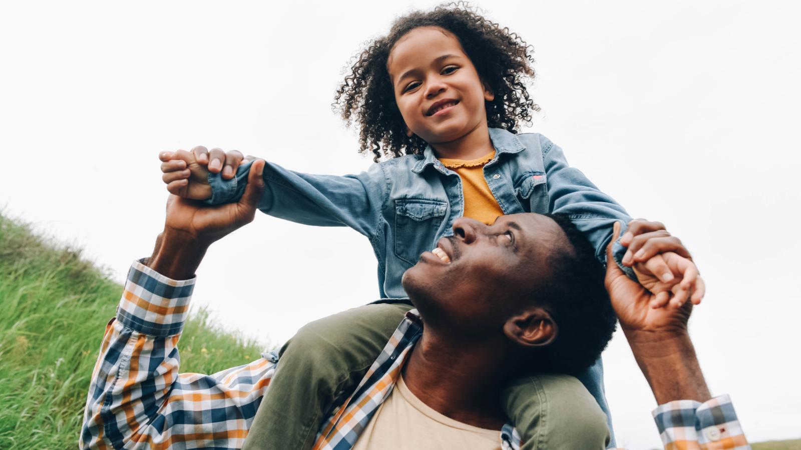 Father holding child on shoulders