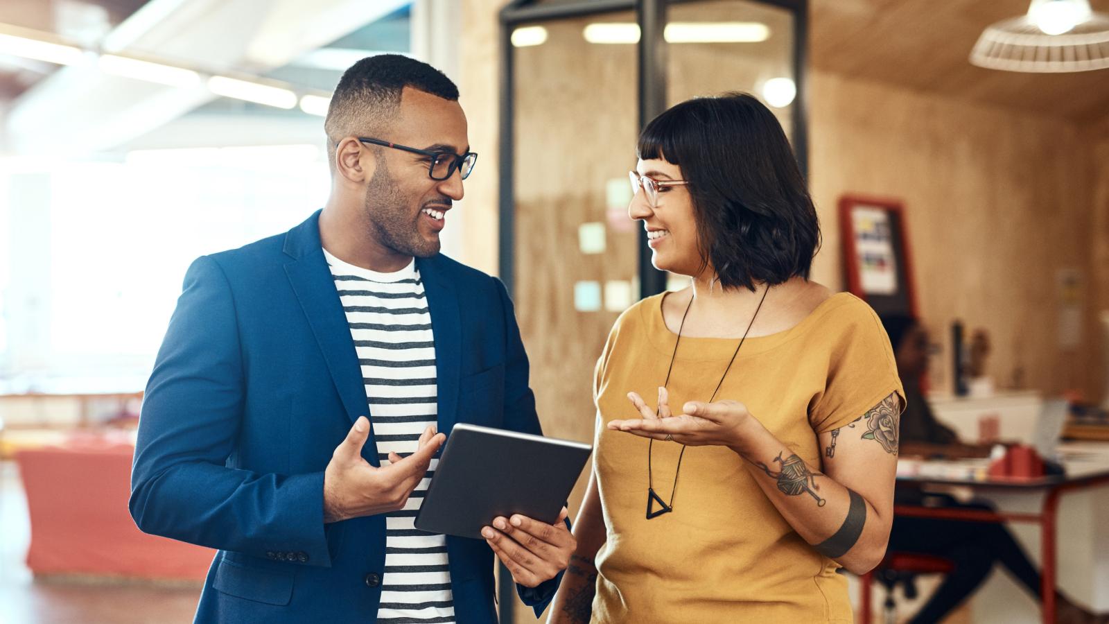 Two colleagues talking in an office.