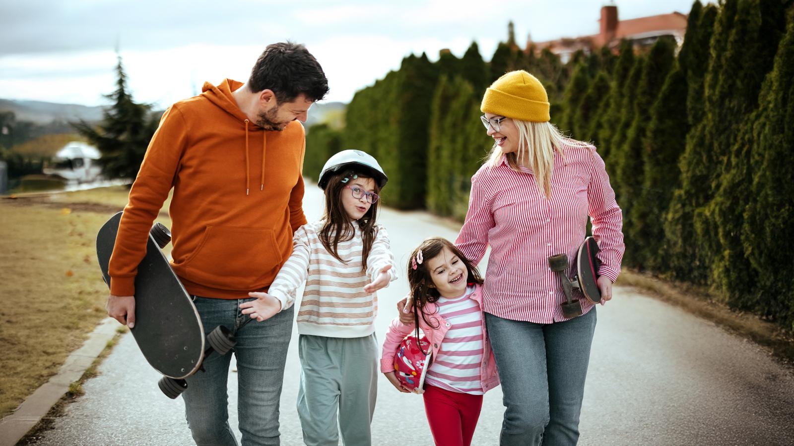 Happy family walks down the street
