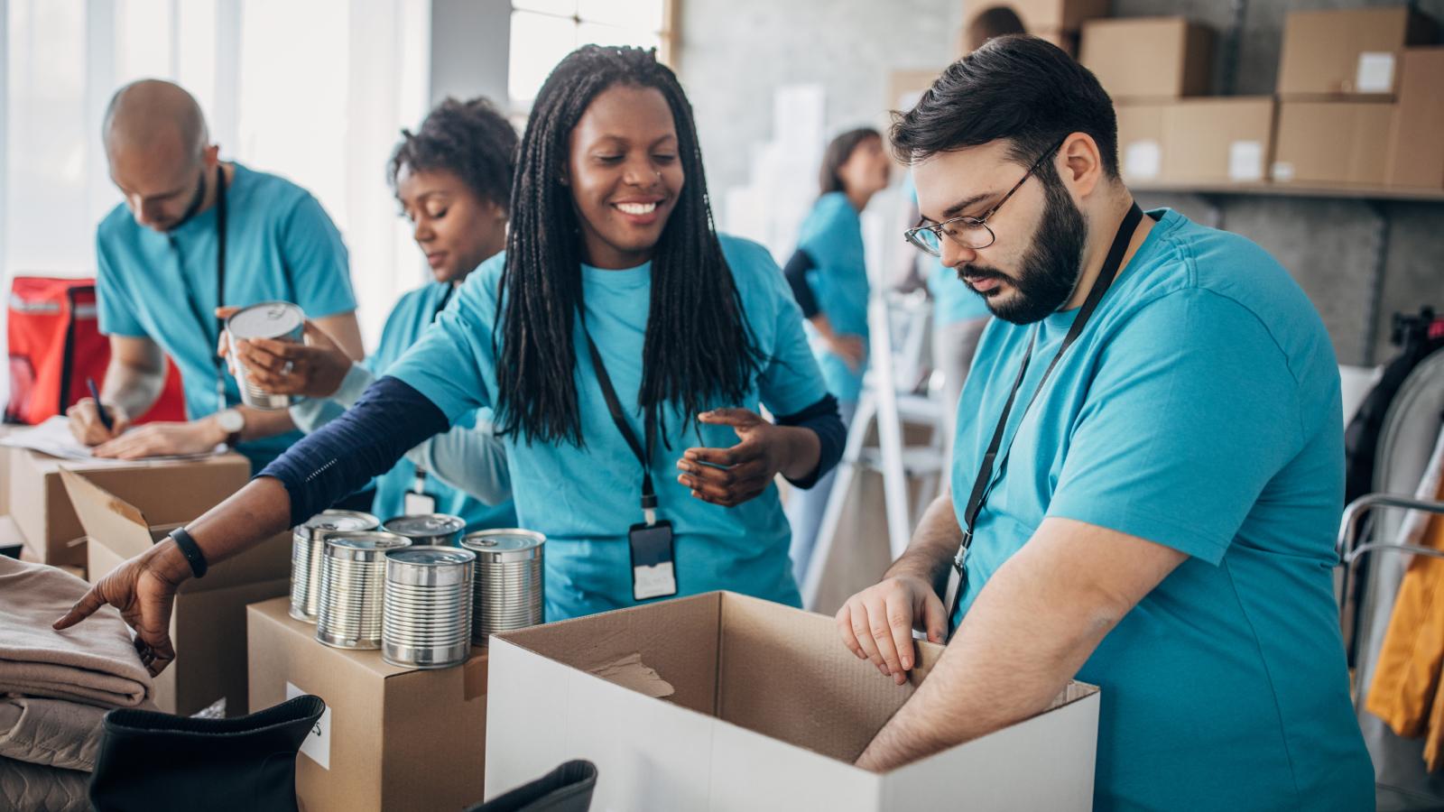 Diverse volunteers packing donation boxes