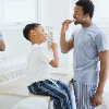 Father and son brushing their teeth