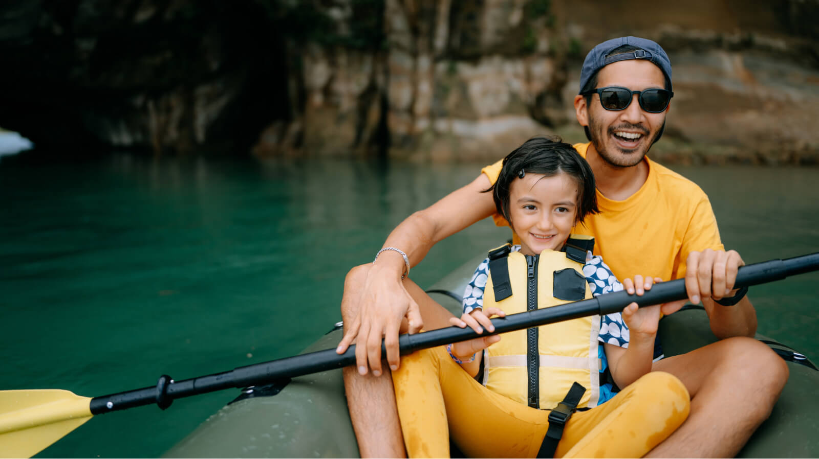 Father and child happily enjoying ride in kayak
