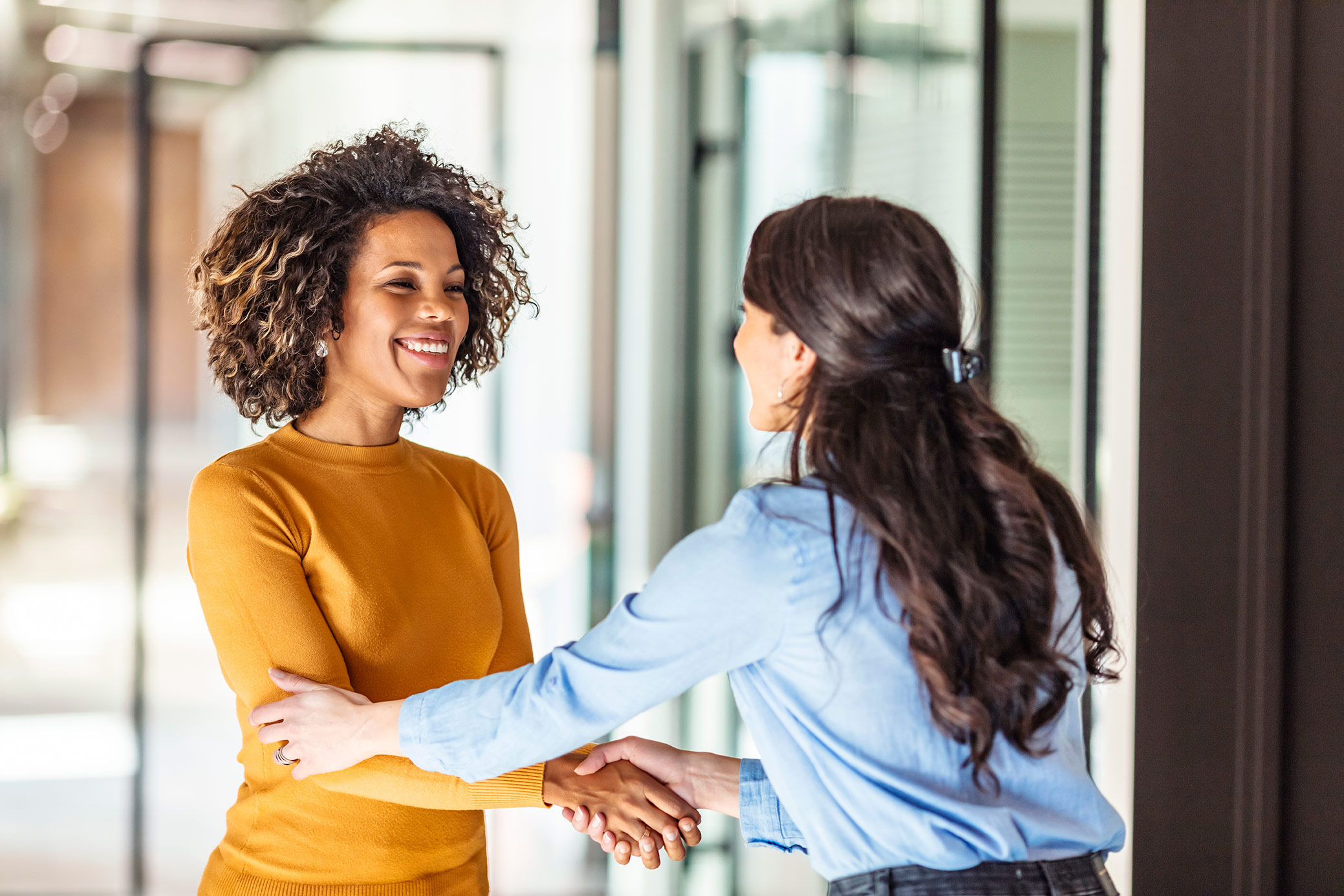 Two women shaking hands